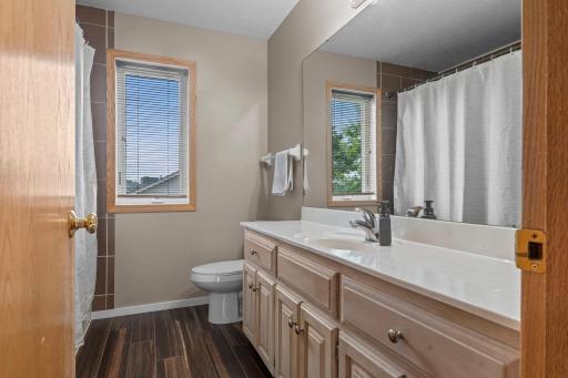 Updated bath has a large vanity and tile shower