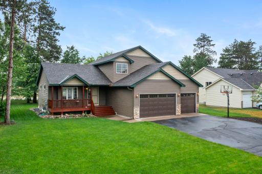 The exterior of the home has great curb appeal set amongst tall pines and features newer siding and roof