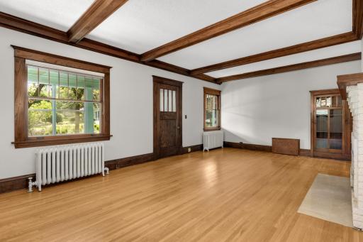Note the refinished hardwood floors throughout - main floor living room (door in photo leads to foyer and front porch)