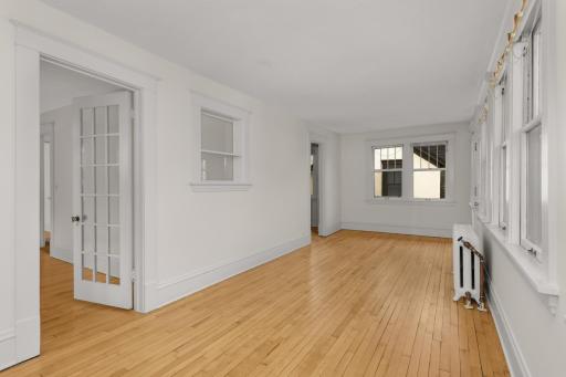 Different angle of the living room - french door on the left leads to bedroom 1 and door toward back of the photo leads to the kitchen