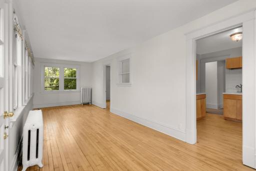 Note the refinished hardwood floors throughout the upper unit