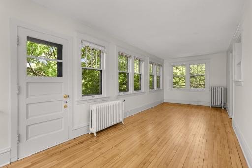 Living room in second floor unit - door on the left leads to deck and bac k exterior stairway