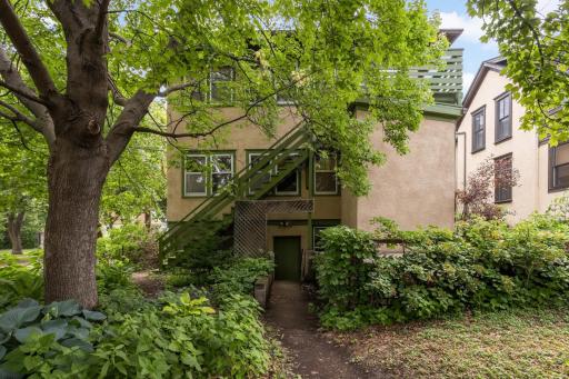 Photo of backyard, staircase from upper unit, and back door from lower level