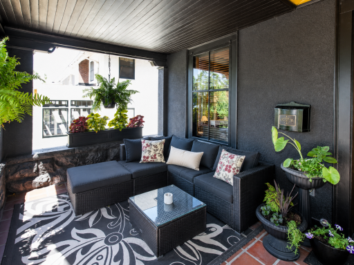 The elevated stone porch evokes the charm of a New Orleans veranda