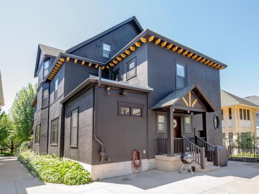The shared driveway opens to a thoughtfully designed, low-maintenance backyard featuring a patio and a rare three-car garage