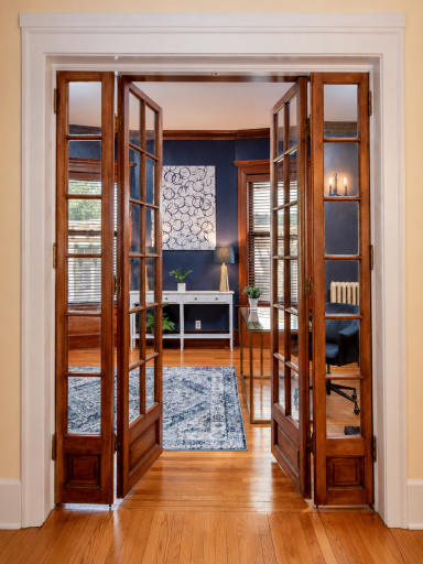 Behind elegant glass French doors, a distinguished library provides an inspiring space to work from home