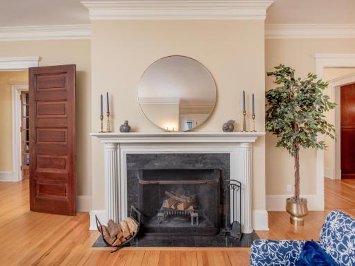 A gracious parlor designed for elegant entertaining, charitable gatherings, and celebrations, featuring a stately wood-burning fireplace with a beautifully crafted original hearth