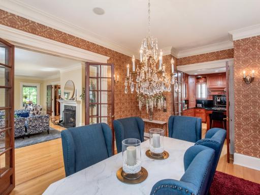 A double set of French doors frames the formal dining room, offering privacy while maintaining an open, gracious flow