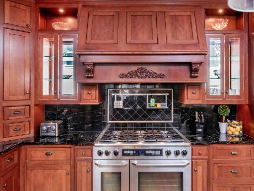 This beautifully appointed eat-in kitchen showcases glass-front cabinetry, rare pass-through windows, and a professional-grade six-burner Dacor range with double convection ovens