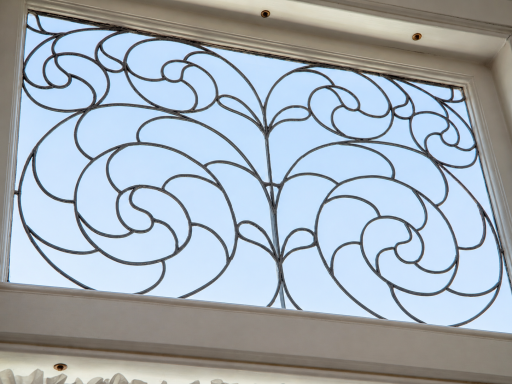 Intricate curved detailing top the stairwell bay windows