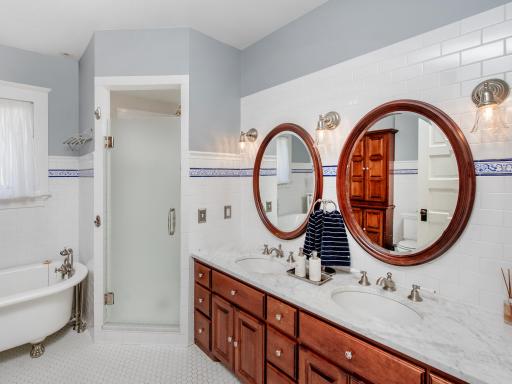 A spacious full bathroom with a clawfoot soaking tub and walk-in shower completes this level