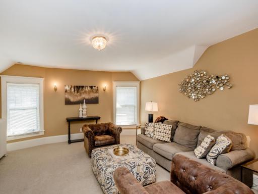 The centrally located family room offers a gracious retreat for conversation, movie nights, and everyday relaxation