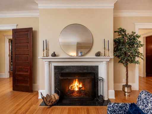 A gracious parlor designed for elegant entertaining, charitable gatherings, and celebrations, featuring a stately wood-burning fireplace with a beautifully crafted original hearth