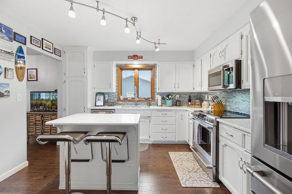 Bright, all-white kitchen w/ stainless appliances