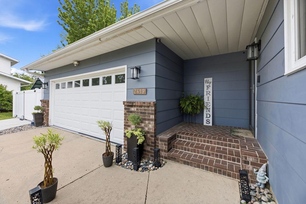 Covered, private front entry with brick steps