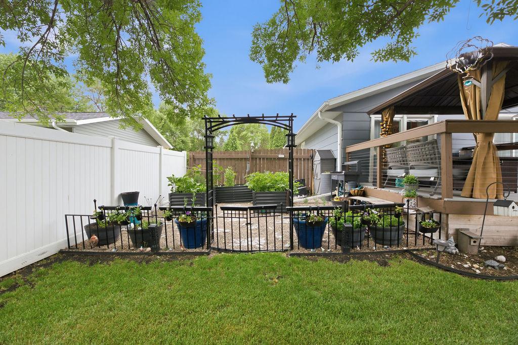 Fenced, raised garden bed area or great Patio space!