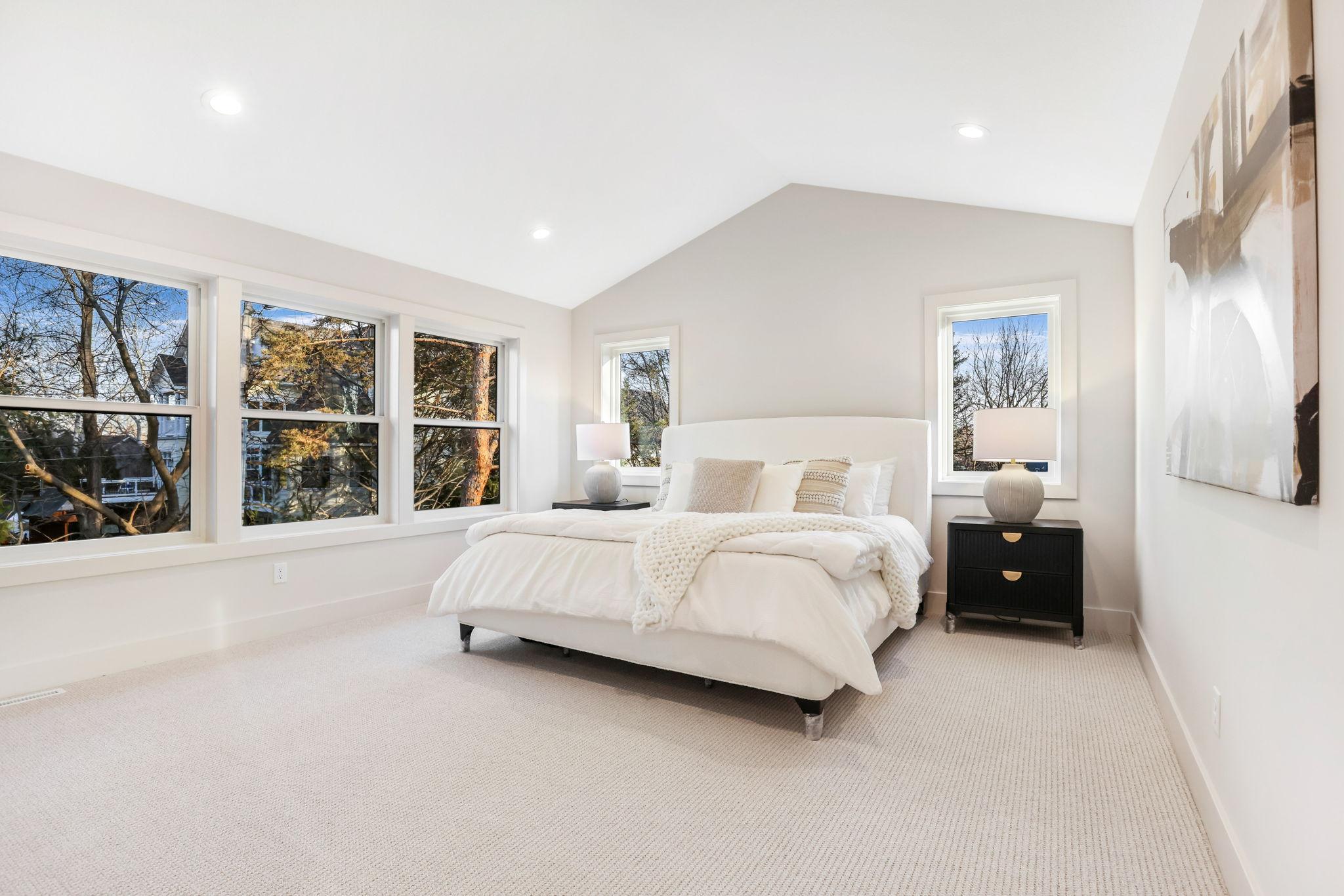 The primary bedroom is a serene retreat with an impressive vaulted ceiling that enhance the sense of space.