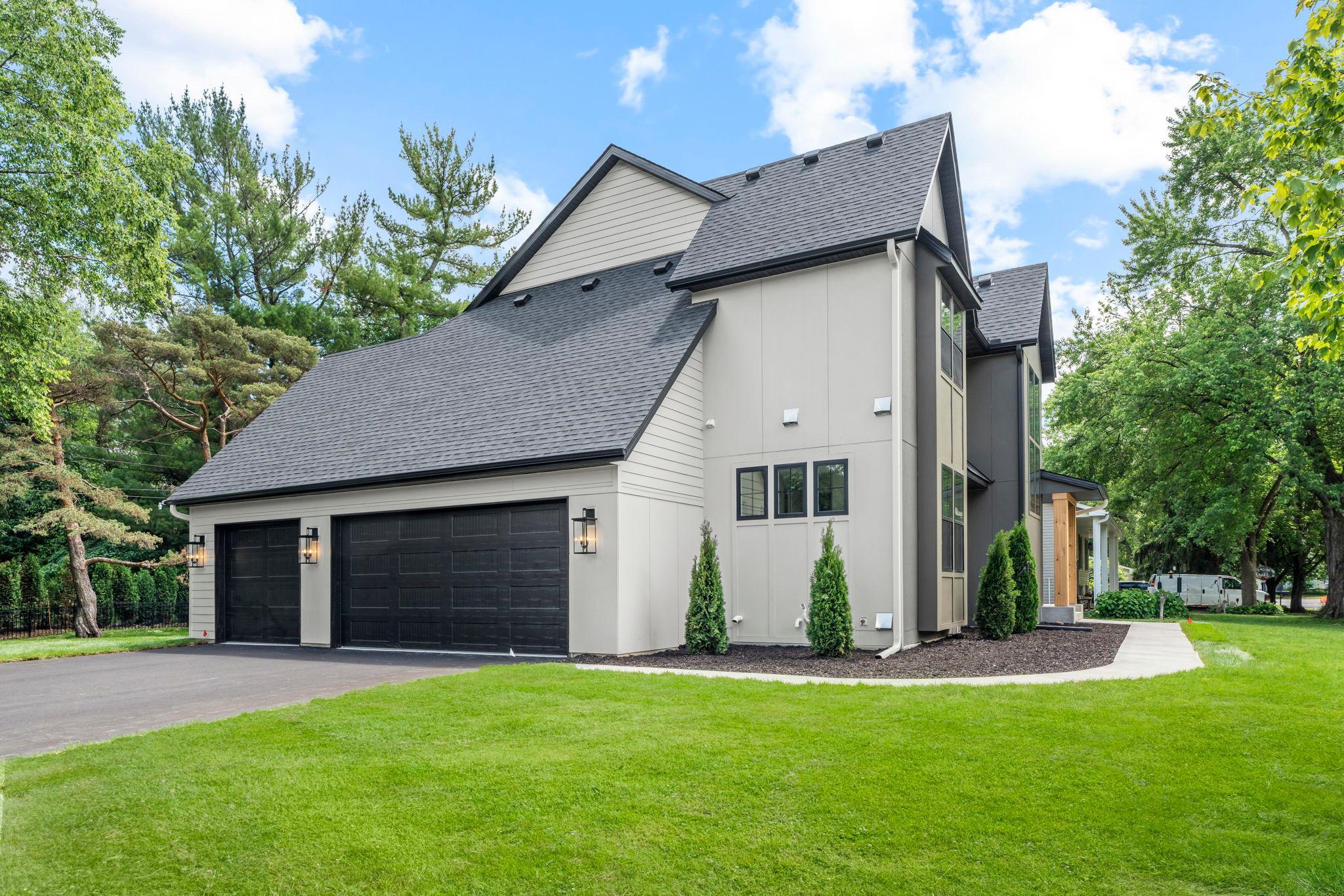 The insulated three car garage is designed for Minnesota living, featuring a floor drain and a gas line rough-in for a future heater.