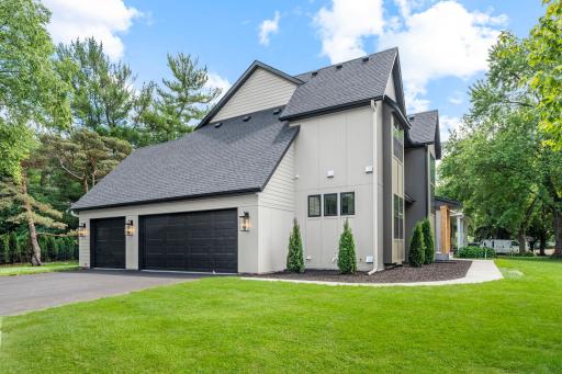 The insulated three car garage is designed for Minnesota living, featuring a floor drain and a gas line rough-in for a future heater.