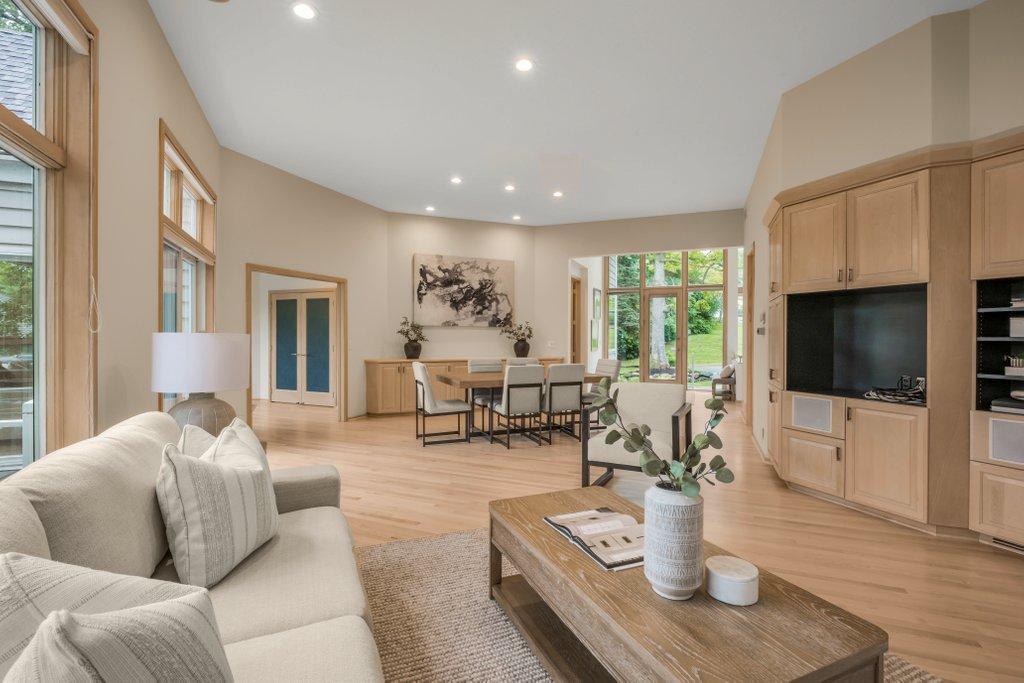Living room showing built-in cabinetry and dining area behind with built-in buffet and storage.