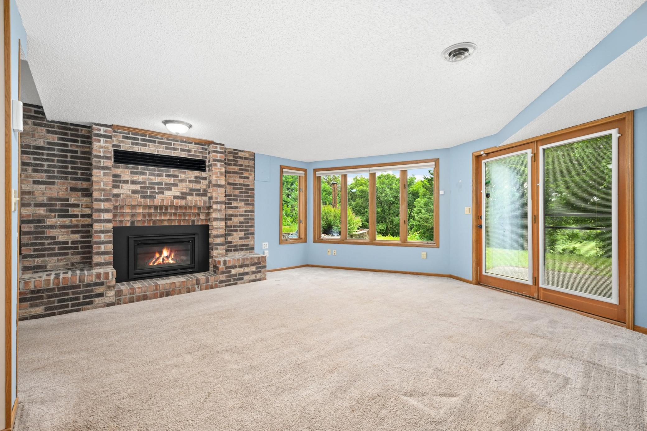 The Lower Level Offers and Abundance of Addition Living Space with Multiple Living Spaces Centered Around a Two-Sided Fireplace.