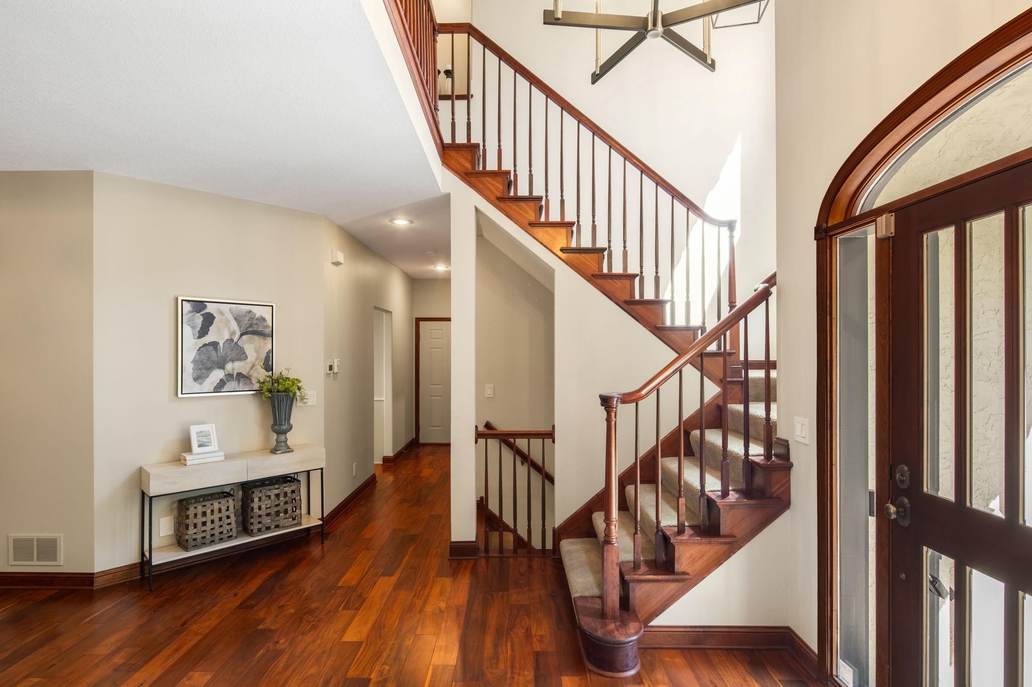 Warm wood flooring runs throughout the main level, complemented by 9-ft ceilings.