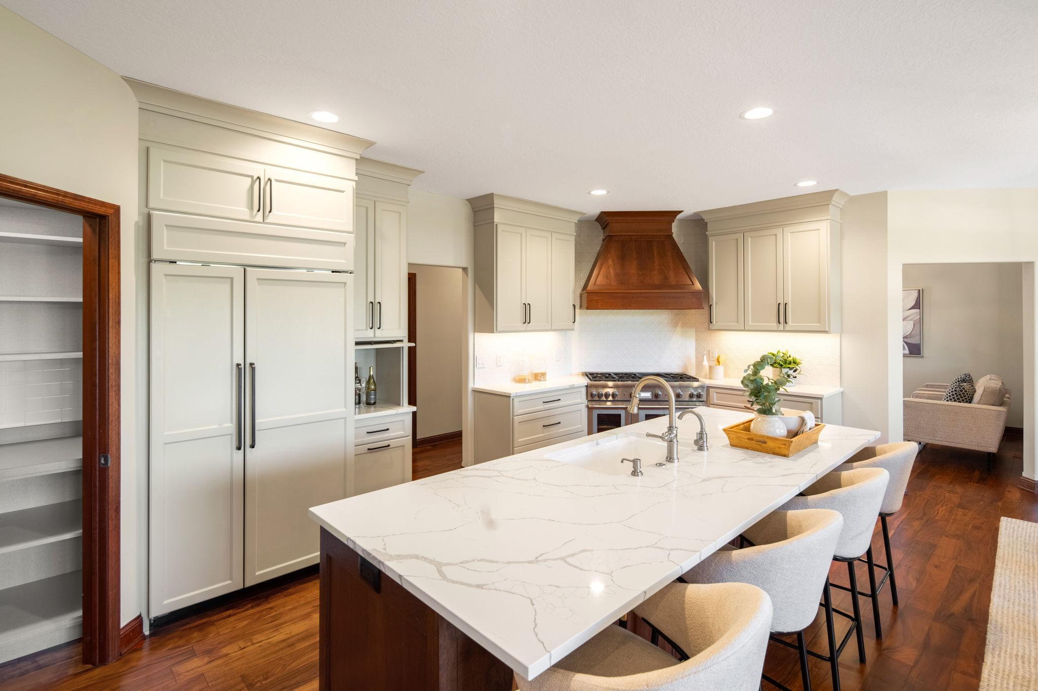 Featuring high-end stainless-steel appliances including a double Thermador oven and vent hood.