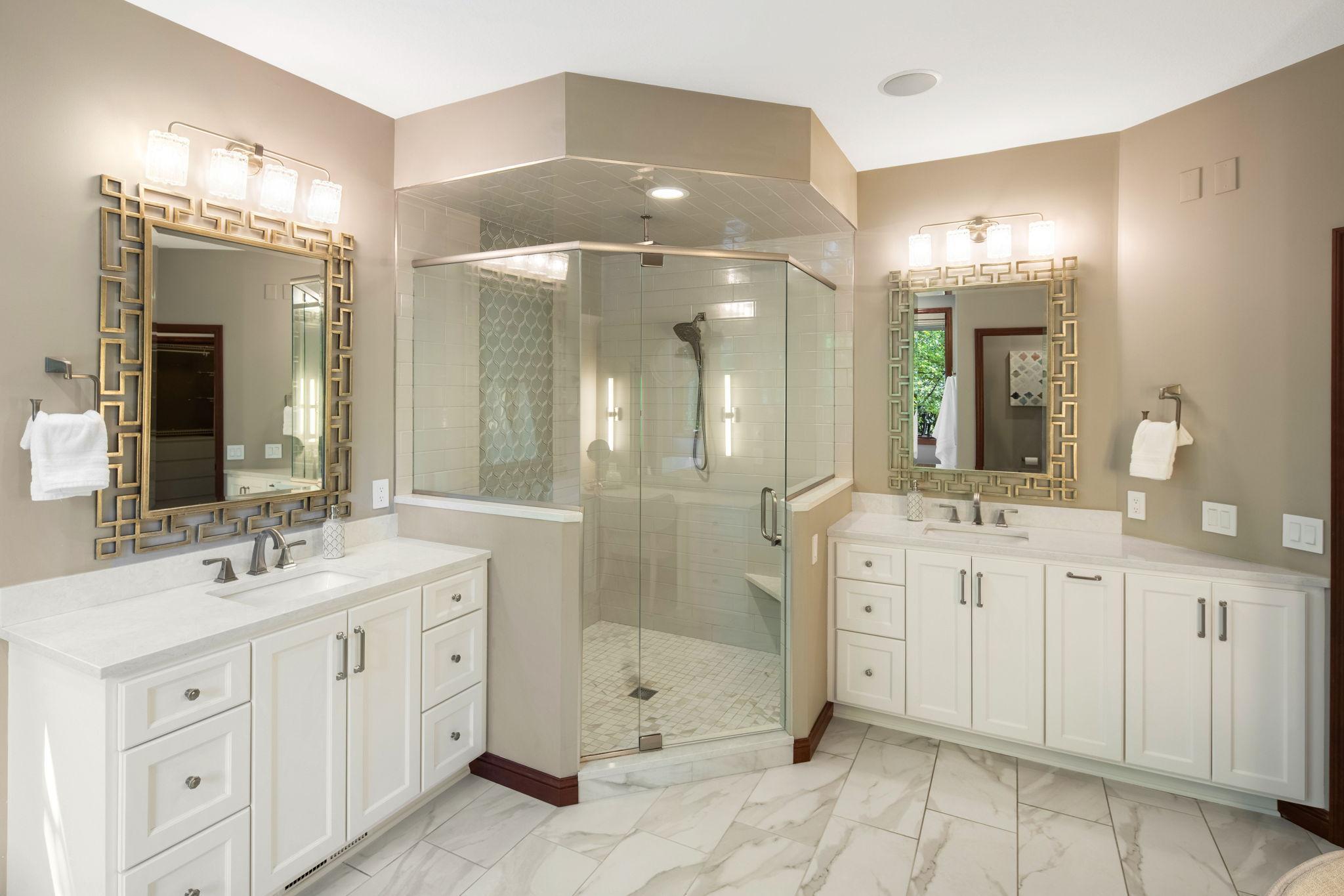 Dual vanities, complemented by generous linen storage.