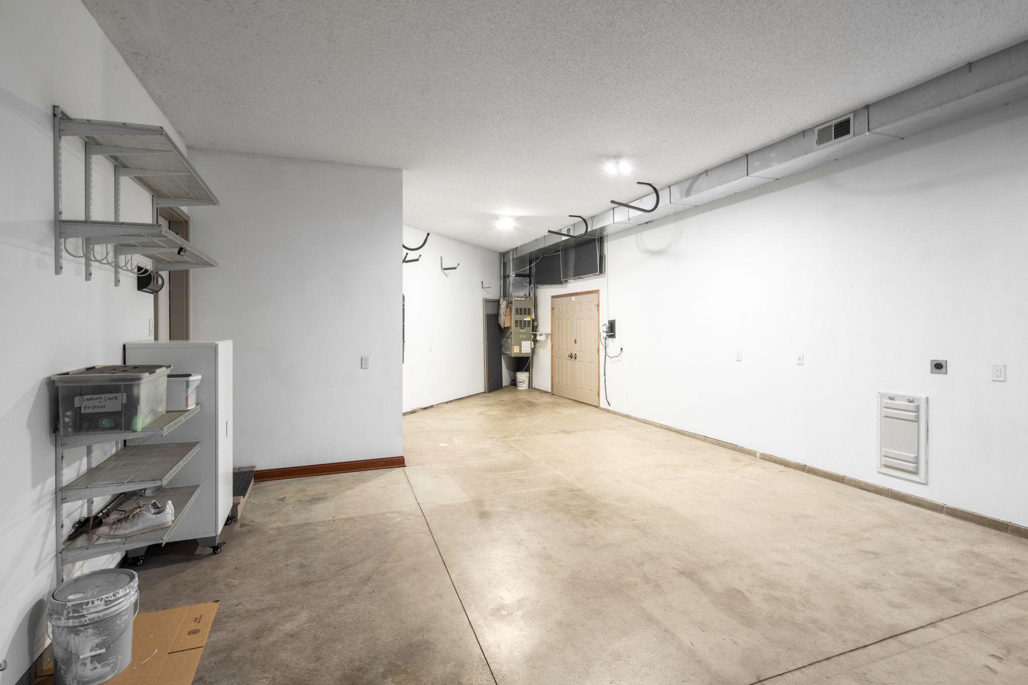 The oversized 1,100 sqft four-car garage includes a dedicated Rheem furnace, making it ideal for hobbies, storage, and lake lifestyle gear.