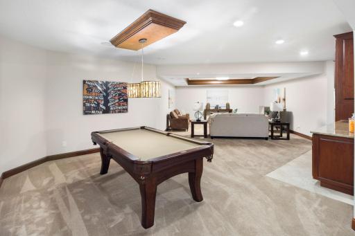 Recreation/game area with comfortable finishes and statement lighting.