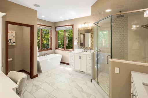 The ensuite bath includes a tiled walk-in rain shower and free-standing tub.