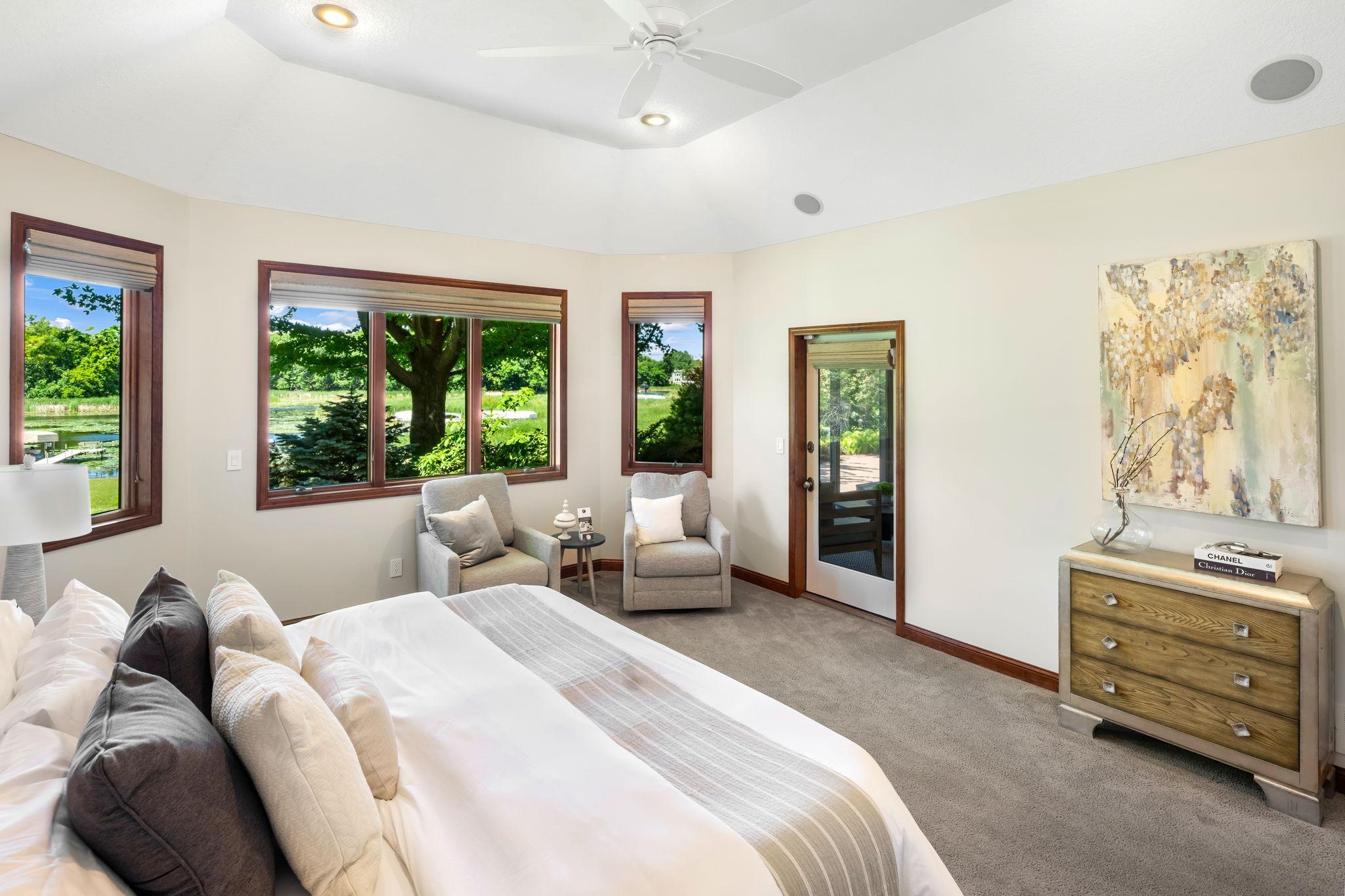 Coved 11-ft ceiling, plush carpeting, and private walkout access to the screened porch.