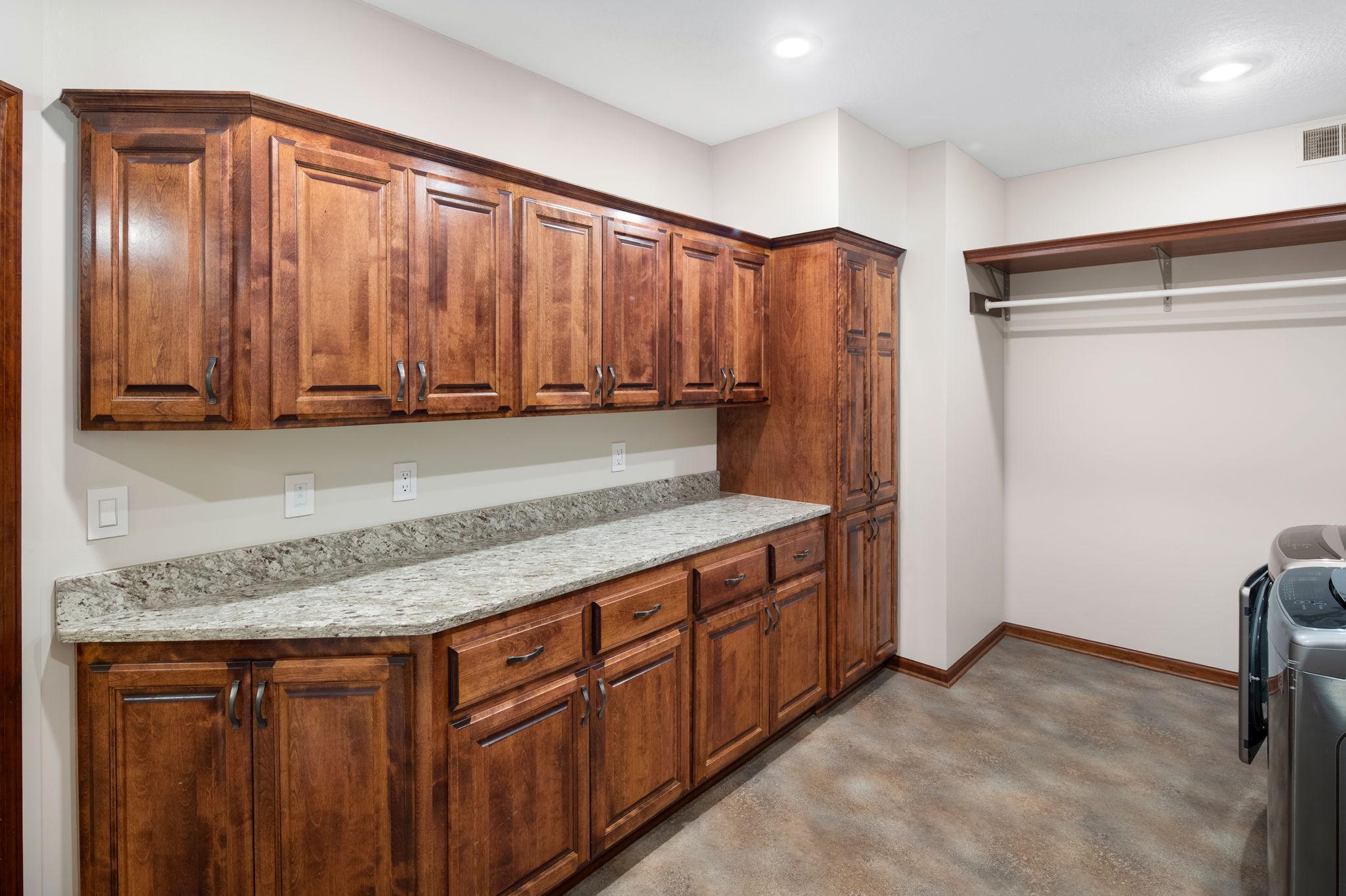 Abundant cabinetry, counterspace, and utility sink.