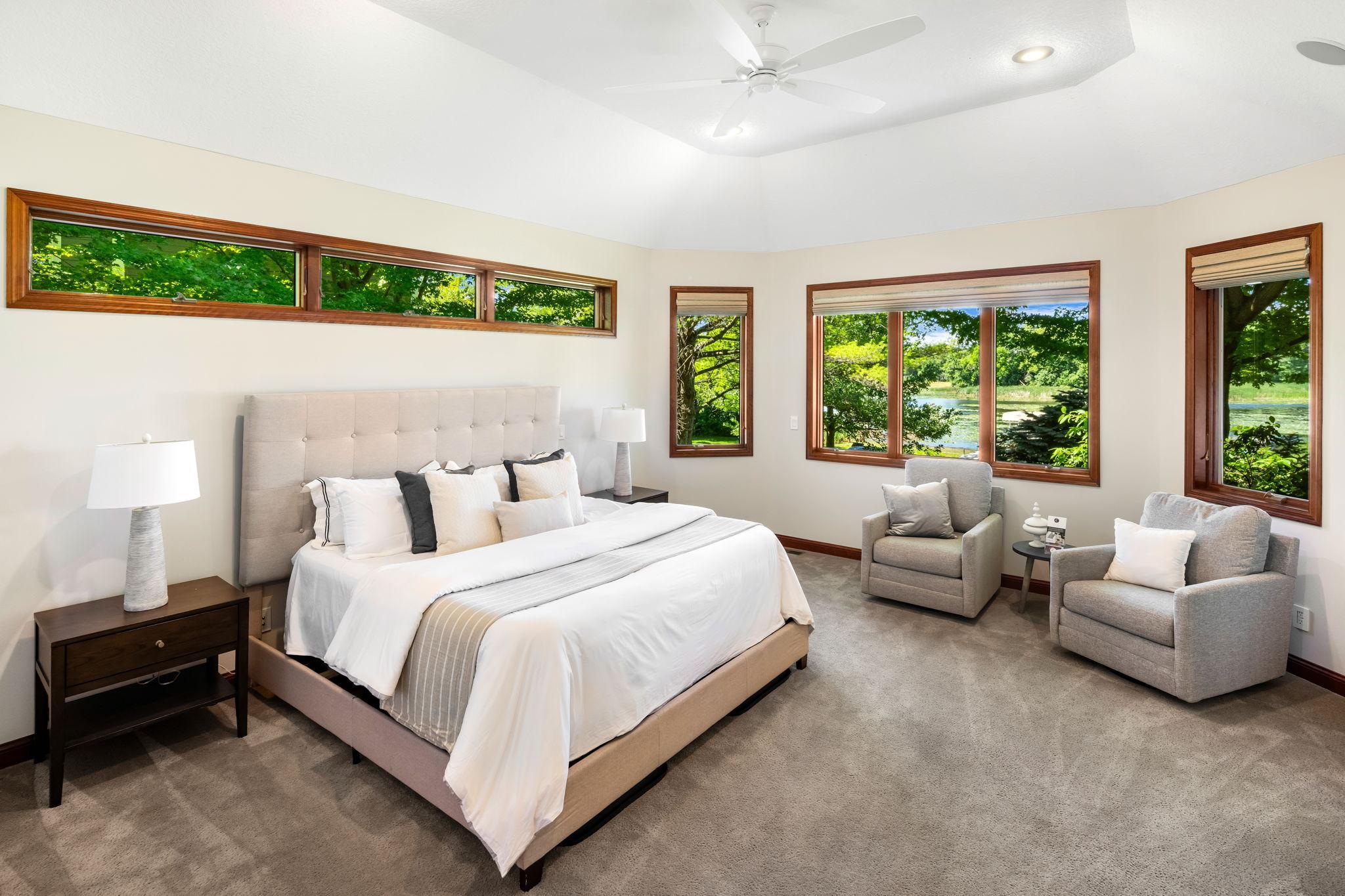 The main-level primary suite offers a true retreat with lake views.