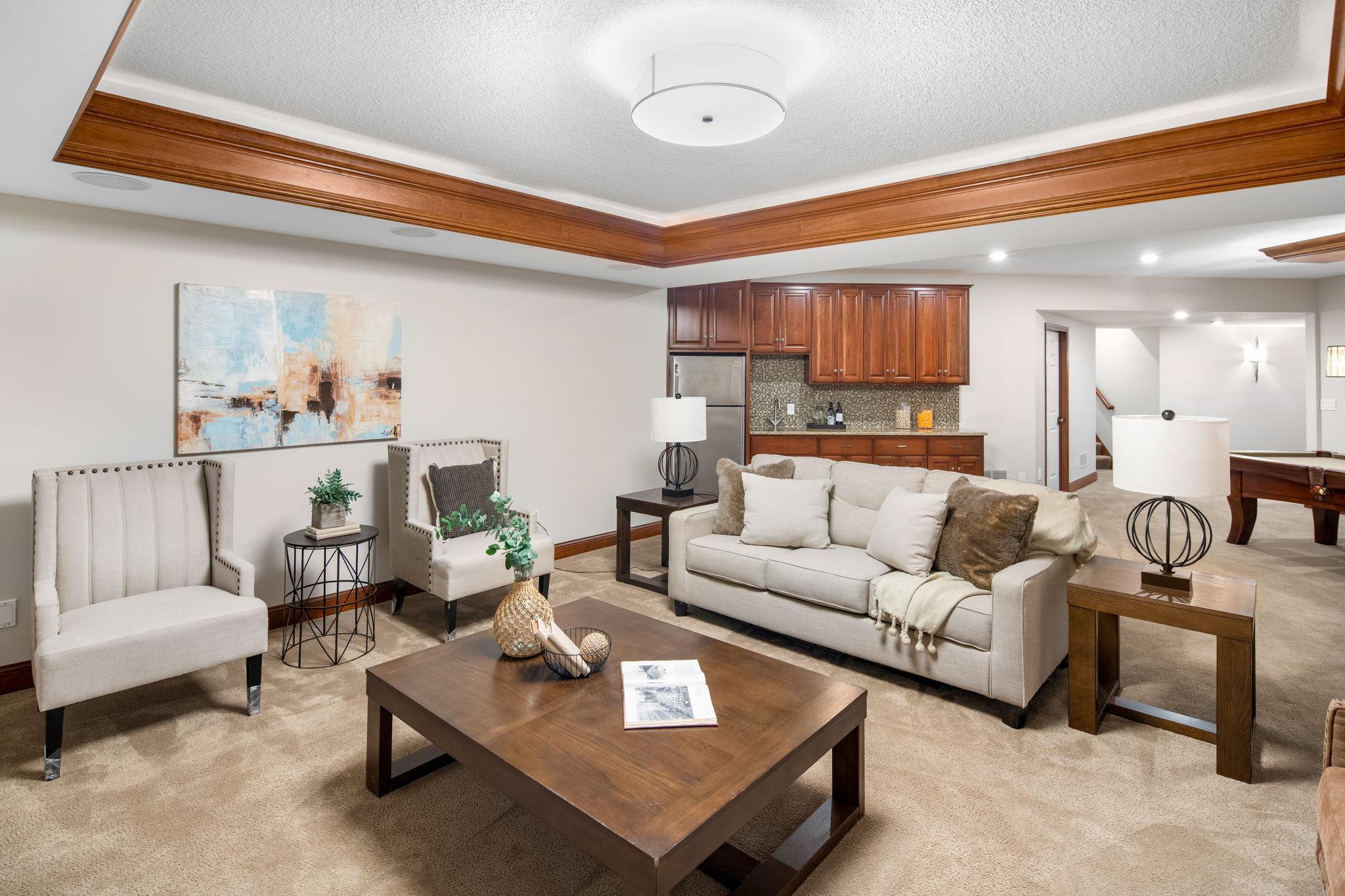 The lower level is designed for entertaining and flexibility, offering a spacious family room with tray ceiling lighting and surround sound.