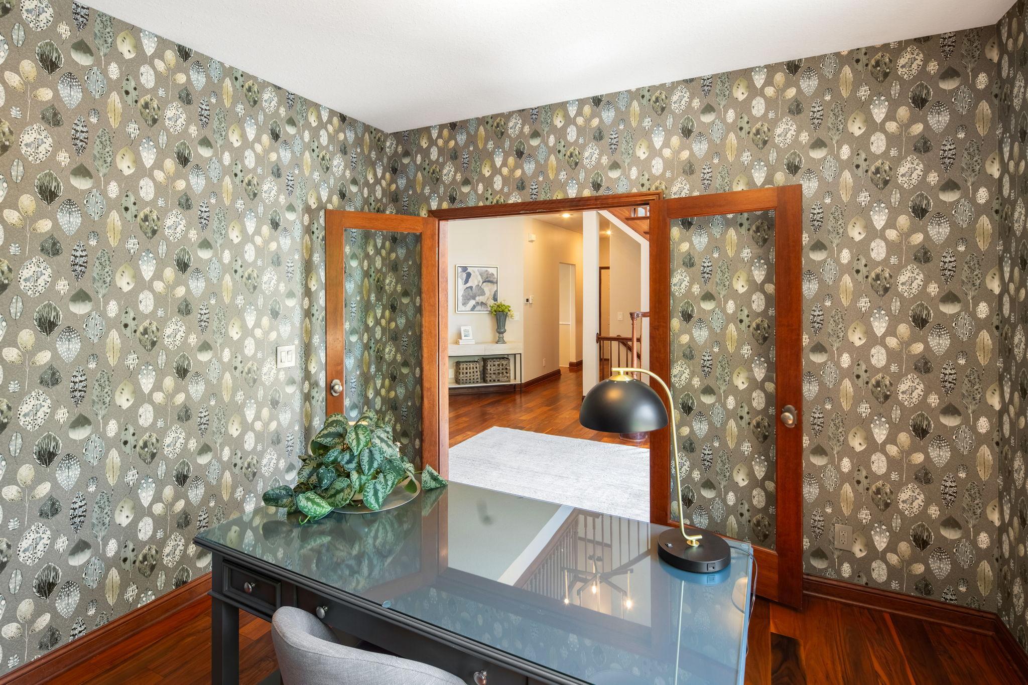 Main-level office with French glass doors and abundant natural light.