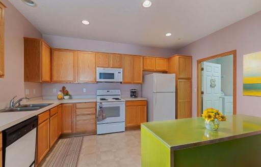 The kitchen has lots of cabinet and counter space. Plus, there is easily room for an island or an eat-in kitchen table in the corner. This photo was virtually staged.