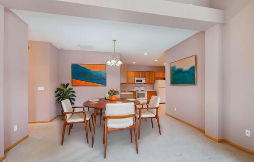 There is an informal dining room adjacent to the kitchen and living room. This photo was virtually staged.