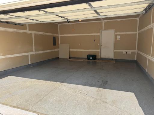 The two-car garage has a painted floor, is drywalled, and has lots of storage room.