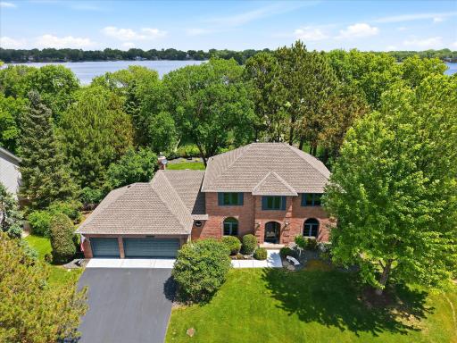 Beautifully landscaped front yard with mature trees and shrubs. Irrigation system with Racio wifi controller keeps the lawn green. New architectural shingle roof in 2024.