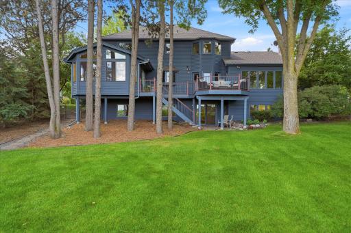 Beautiful canopy of mature trees provides ample shade while allowing nice lake view. Plenty of backyard space for fun with family and friends