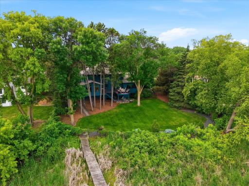 Beautiful backyard with mature trees and plenty of level play space for entertaining and kids/pets to play.