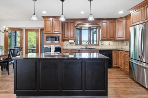 Stainless steel appliances inc. new GE refrigerator + GE profile double ovens (one convection), quality induction cooktop, recessed lights, tile backsplash, wood floors and great lake views from large bay window