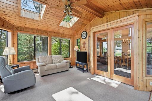 Four Season Porch with vaulted ceiling w/skylights and private lake views. Heating/cooling furnace air ducts along with supplemental heating electric baseboard heaters