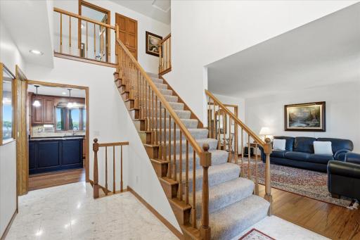 Majestic two story Entry w/marble tile flooring and window above w/matching tile ledge. Beautiful chandelier light fixture and open staircase to above