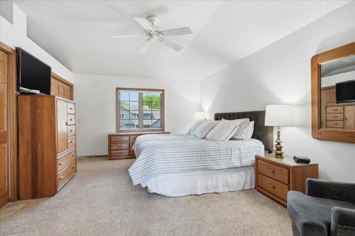 Spacious Upper Level Primary Bedroom Suite features: dual closets and ceiling fan