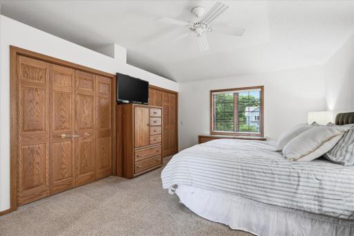 Spacious Upper level Primary Bedroom Suite features: dual closets and ceiling fan