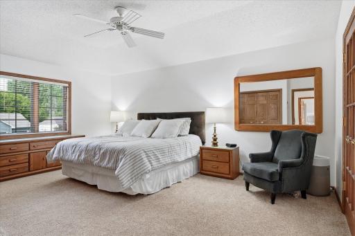 Spacious Upper level Primary Bedroom Suite features: dual closets and ceiling fan