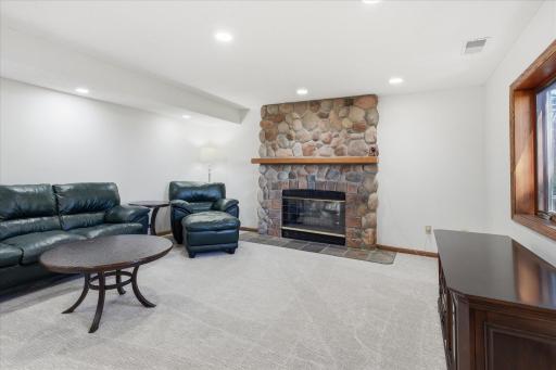 Amusement and exercise Rooms with walk-out patio door to back patio and backyard, cozy gas fireplace w/stone surround. Sellers haven't used fireplace in many years and not sure of condition