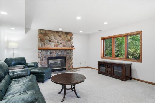 Lower level Amusement Room with walk-out patio door to back patio and backyard, cozy gas fireplace w/stone surround, custom wet bar with granite counter top, recessed lights and great lake views. Sellers haven't used fireplace in many years